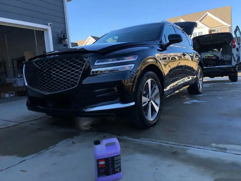 Dark blue SUV after a mobile detail in a driveway